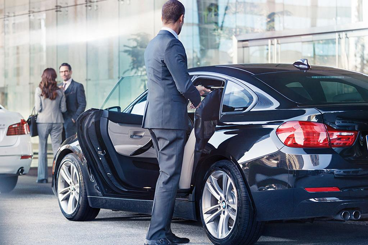 Uniformed chauffeur delivering Homer Glen Limo Service to an executive client